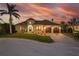 A stunning two-story home features lush landscaping, a long driveway, and a two-car garage at 257 Lido Dr, Punta Gorda, FL 33950