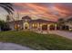 Beautiful single-story home featuring a well-manicured lawn, circular entryway, and three-car garage at 257 Lido Dr, Punta Gorda, FL 33950