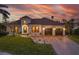 Charming waterfront home with a tile roof, circular tower entrance, and a two-car garage at 257 Lido Dr, Punta Gorda, FL 33950