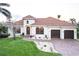 Inviting home showcasing a beautiful exterior, lush lawn, and meticulously manicured landscaping at 257 Lido Dr, Punta Gorda, FL 33950