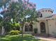 Charming home features a rounded turret entry with blooming flowers and a well-manicured lawn at 257 Lido Dr, Punta Gorda, FL 33950