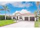 Charming waterfront home with a tile roof, circular tower entrance, and a two-car garage at 257 Lido Dr, Punta Gorda, FL 33950