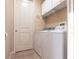 Small laundry room featuring washer, dryer, cabinets, and tile floors at 257 Lido Dr, Punta Gorda, FL 33950