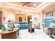 Bright living room with tray ceilings, ceiling fan, and a large leather sectional sofa at 257 Lido Dr, Punta Gorda, FL 33950