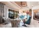 Comfortable living room features a tray ceiling with fan, stylish furniture, and sliding glass doors to the outdoors at 257 Lido Dr, Punta Gorda, FL 33950