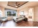 Serene main bedroom with a tray ceiling, large window, and ensuite bathroom access at 257 Lido Dr, Punta Gorda, FL 33950