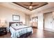 Comfortable main bedroom with neutral tones, ceiling fan, hardwood floors, and ample natural light at 257 Lido Dr, Punta Gorda, FL 33950