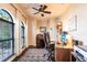 Cozy home office featuring wood floors, a ceiling fan, and large windows, perfect for a productive workspace at 257 Lido Dr, Punta Gorda, FL 33950