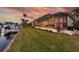 Back of the property with an expansive screened-in lanai and lush lawn down to the canal at 257 Lido Dr, Punta Gorda, FL 33950