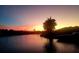 Sunset reflects warm colors on the waterfront, showcasing a serene view at 257 Lido Dr, Punta Gorda, FL 33950
