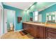 Bright bathroom featuring double sinks with wood cabinets and a separate toilet room at 258 Venezia Ct, Punta Gorda, FL 33950