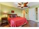 Bedroom featuring a ceiling fan, hardwood floors, and closet at 258 Venezia Ct, Punta Gorda, FL 33950