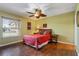 Comfortable bedroom with a ceiling fan, hardwood floors, and plenty of natural light at 258 Venezia Ct, Punta Gorda, FL 33950