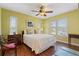 Cozy bedroom with a ceiling fan, hardwood floors, and plenty of natural light at 258 Venezia Ct, Punta Gorda, FL 33950