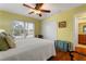 Comfortable bedroom with a ceiling fan, hardwood floors, and walk-in closet at 258 Venezia Ct, Punta Gorda, FL 33950
