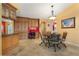 Dining area adjacent to a home office with custom cabinetry, granite countertops, and access to the kitchen at 258 Venezia Ct, Punta Gorda, FL 33950