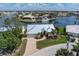 Charming waterfront home with manicured lawn, mature trees, and a private boat dock at 258 Venezia Ct, Punta Gorda, FL 33950