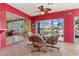 Cozy Florida room with canal views and bright red accent wall at 258 Venezia Ct, Punta Gorda, FL 33950