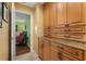 Hallway with built-in cabinets and granite countertops leading to a bedroom with hardwood floors at 258 Venezia Ct, Punta Gorda, FL 33950