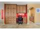 Home office area with built-in cabinets, granite countertops, a desk, and red accent wall at 258 Venezia Ct, Punta Gorda, FL 33950
