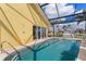 Back of home with a pool, screened in porch, and boat access to the river or lake at 258 Venezia Ct, Punta Gorda, FL 33950