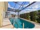 Enclosed pool area with canal access and tropical landscaping offers private outdoor living at 258 Venezia Ct, Punta Gorda, FL 33950