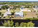 Aerial shot showcasing the screened pool, landscaping, and canal-front location of the property at 3024 Caribbean Dr, Punta Gorda, FL 33950