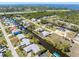 Scenic aerial view of a waterfront community with homes on canals and access to a wide bay at 3024 Caribbean Dr, Punta Gorda, FL 33950