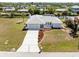 Home with landscaping, spacious driveway, and easy access to the canal at 3024 Caribbean Dr, Punta Gorda, FL 33950