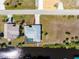 Aerial view of a home with a screened-in pool and canal access, showcasing its neighborhood location at 3024 Caribbean Dr, Punta Gorda, FL 33950