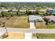 Aerial view showcasing a home with a large yard and a canal behind the property at 3024 Caribbean Dr, Punta Gorda, FL 33950