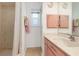 Bathroom featuring a pink vanity cabinet with decorative accents and a walk-in shower at 3024 Caribbean Dr, Punta Gorda, FL 33950