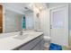 Bathroom featuring a modern vanity with a large mirror, a shower, and a toilet with blue rug at 3024 Caribbean Dr, Punta Gorda, FL 33950
