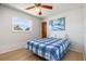 Bright bedroom featuring a blue plaid bedspread and a window with outdoor views at 3024 Caribbean Dr, Punta Gorda, FL 33950