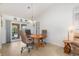Cozy dining room with hardwood flooring, fan, and seamless access to the pool via sliding door at 3024 Caribbean Dr, Punta Gorda, FL 33950