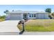 Charming single story home with a well-manicured lawn, attached garage, and inviting screened entryway at 3024 Caribbean Dr, Punta Gorda, FL 33950