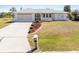 Well-maintained single-story home with a two-car garage, landscaped yard, and a concrete driveway at 3024 Caribbean Dr, Punta Gorda, FL 33950