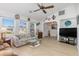 Inviting living room with hardwood flooring, fan, and abundant natural light at 3024 Caribbean Dr, Punta Gorda, FL 33950