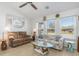 Bright living room with large windows, fan, and neutral tones, providing a cozy atmosphere at 3024 Caribbean Dr, Punta Gorda, FL 33950