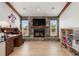 Cozy living room with a stone fireplace, beamed ceiling, and bright natural light at 3024 Caribbean Dr, Punta Gorda, FL 33950
