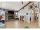 Bright living room features a stone fireplace, ceiling beams, and wood floors at 3024 Caribbean Dr, Punta Gorda, FL 33950