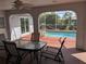 Covered patio with dining table overlooking a tranquil swimming pool and canal at 3024 Caribbean Dr, Punta Gorda, FL 33950