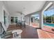Covered outdoor patio featuring dining and seating areas, leading to a screened-in pool at 3024 Caribbean Dr, Punta Gorda, FL 33950