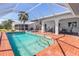 Beautiful pool area surrounded by a screened enclosure and lush landscaping at 3024 Caribbean Dr, Punta Gorda, FL 33950