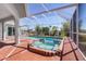 Screened-in pool area featuring a brick patio and a relaxing spa at 3024 Caribbean Dr, Punta Gorda, FL 33950