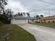 A home with a long driveway and a well-maintained front lawn at 3148 Draper Ter, North Port, FL 34286