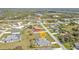 Aerial view showcasing a charming home with an enclosed pool in a quiet neighborhood at 321 Pessoa St, Punta Gorda, FL 33983
