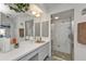 Bright bathroom features a vanity, an enclosed shower with an etched-glass door at 321 Pessoa St, Punta Gorda, FL 33983