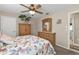 Comfortable bedroom with carpet floor, ceiling fan, and a colorful bedspread with marine design at 321 Pessoa St, Punta Gorda, FL 33983