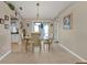 Bright dining room with elegant table, tile floors, and access to the kitchen and living spaces at 321 Pessoa St, Punta Gorda, FL 33983
